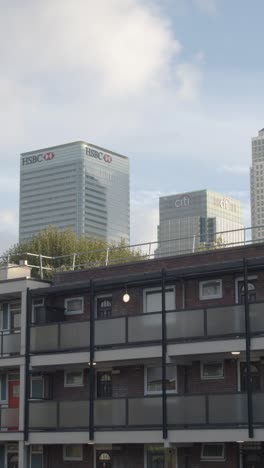 Vertical-Video-Showing-Contrast-Between-Poor-Inner-City-Housing-Development-And-Offices-Of-Wealthy-Financial-Institutions-London-Docklands-UK-4